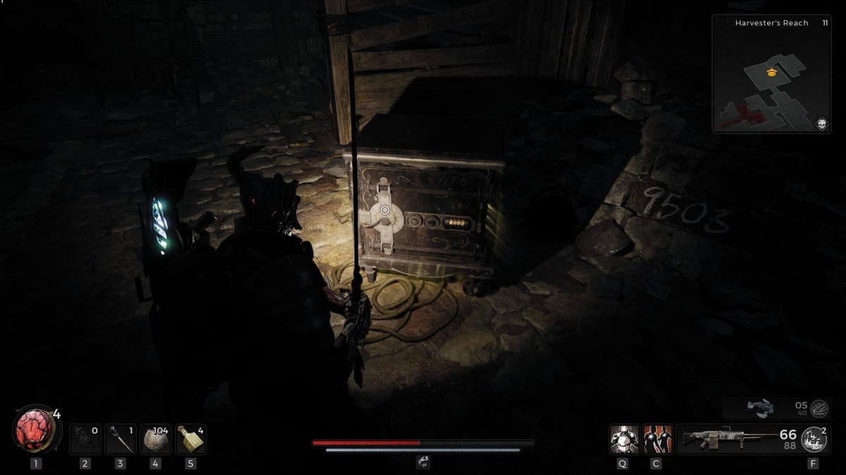 Remnant 2 screenshot with a safe being illuminated by a glowing flashlight while  a man with a sword stands nearby.