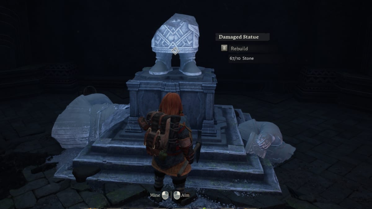 Return to Moria screenshot showing a broken dwarf statue with pieces of rubble lying around
