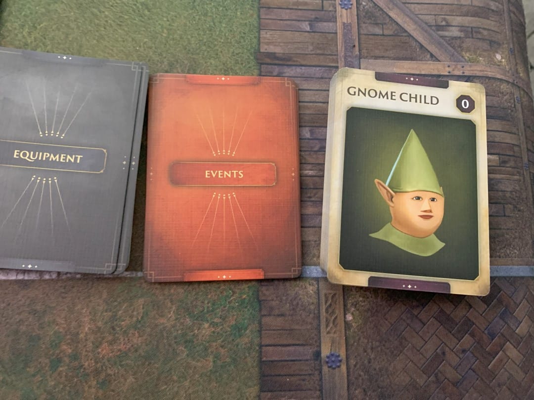 A screenshot of the Equipment Deck, Events Deck, and a deck with a picture of the Gnome Child from Runescape Kingdoms Shadow of Elvarg