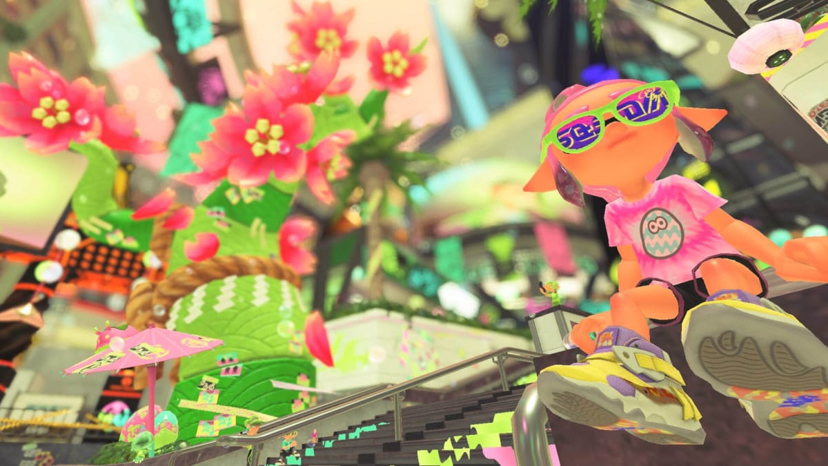 An Inkling sitting on the steps of Splatsville, which has been decked out in colorful Spring Fest decorations, in Splatoon 3