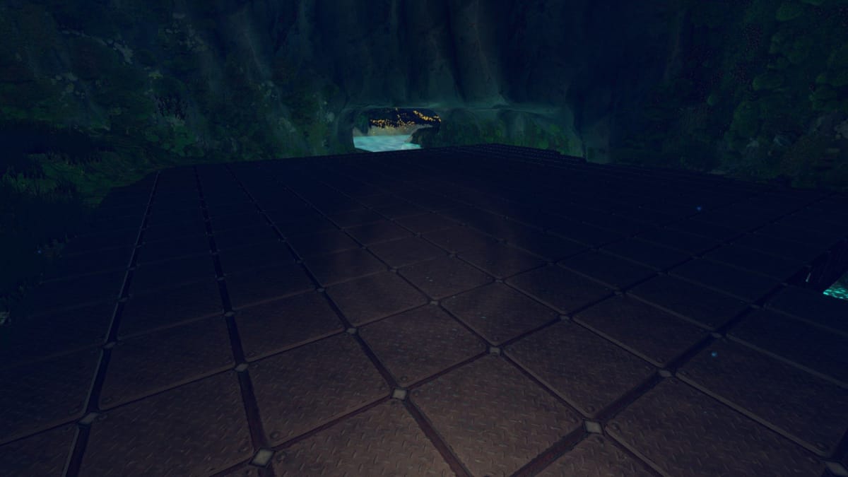 Techtonica screenshot showing off a huge flat expanse of flooring set up above a river in a cave