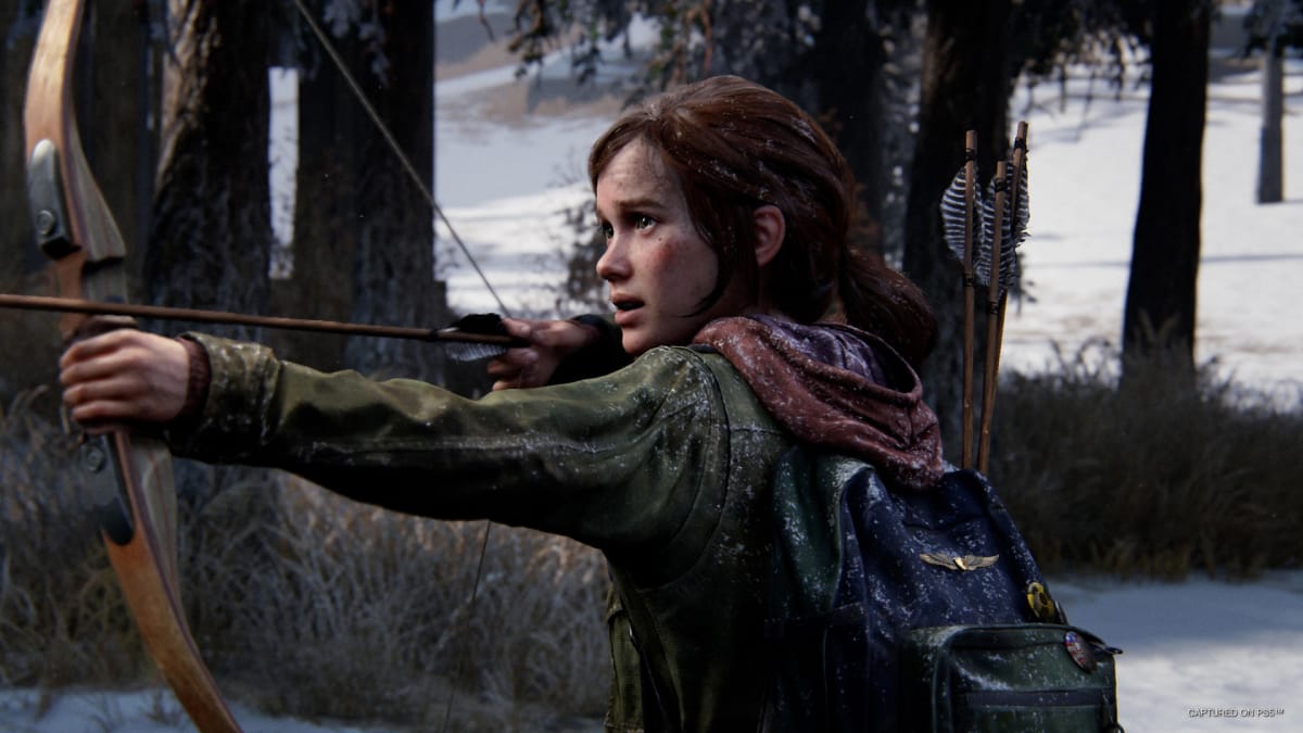 The last of us part 1 gameplay image showing Ellie, the main character, drawing her bow and arrow in the woods. The Last of Us Part 1 accessibility features