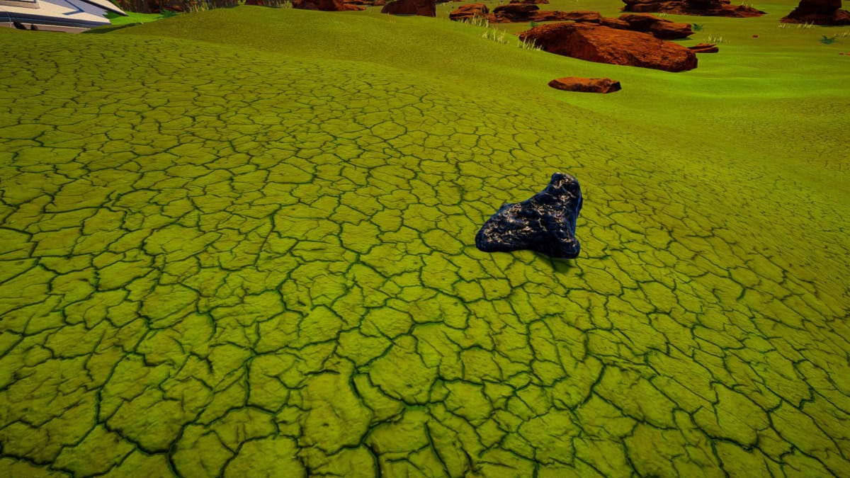 A piece of Silicon on cracked green ground on The Planet Crafter