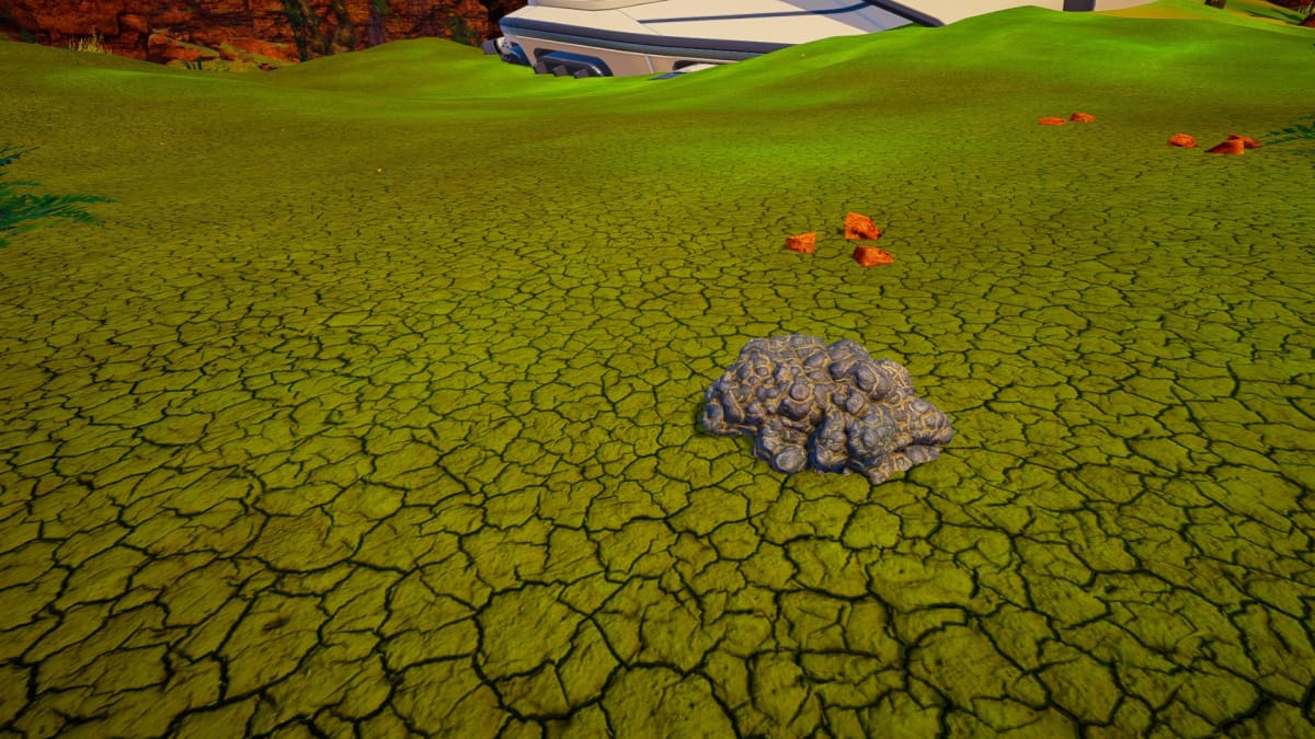 A piece of Titanium on cracked green ground in The Planet Crafter