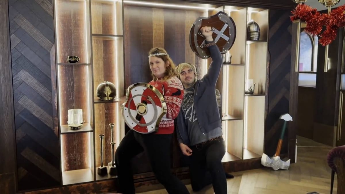 Two Heroic Replicas staffers posing with Valheim replica shields as part of their Valheim merchandise Kickstarter campaign