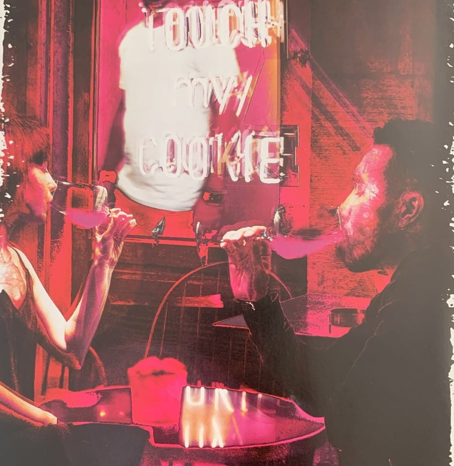 A screenshot of artwork from Vampire: The Masquerade Blood-Stained Love featuring a couple drinking from glasses in a neon-lit diner