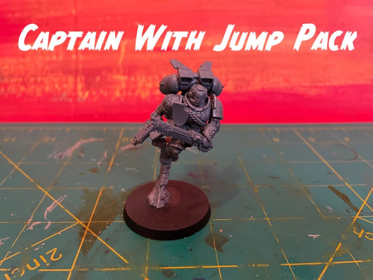 Warhammer 40K Fall 2023 Space Marines - Captain With Jump Pack miniature against a red background