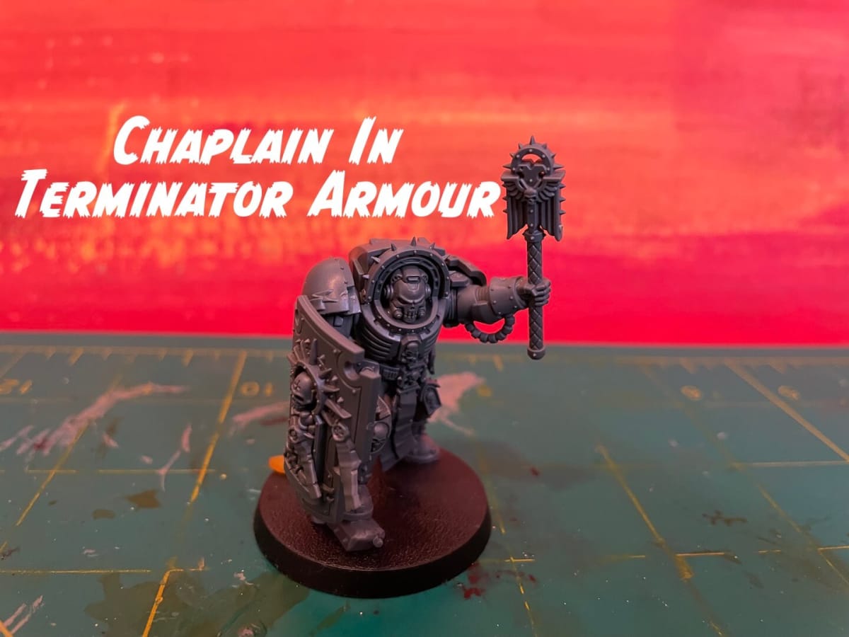 Warhammer 40K Fall 2023 Space Marines - Chaplain in terminator armour mini against a red background