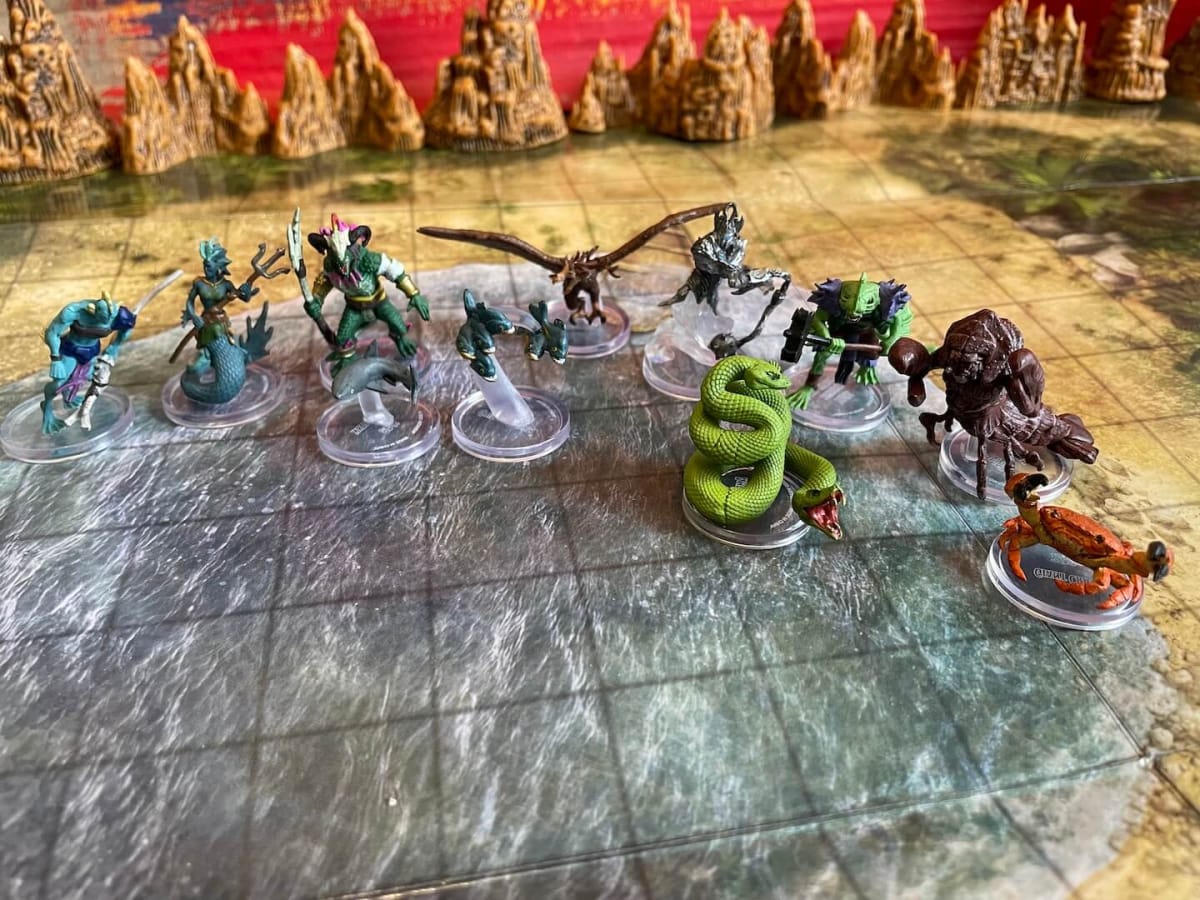 An assortment of Medium sized miniatures from Wizkids Seas and Shores against a beachy background.