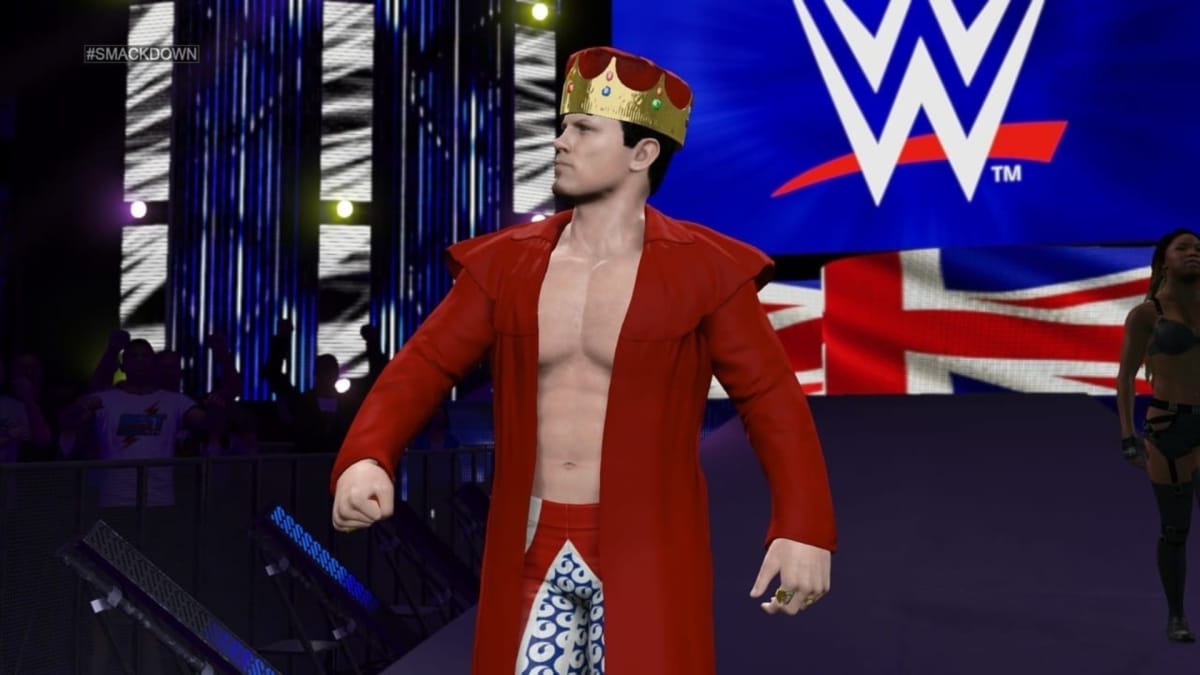 WWE 2K15 screenshot showing a wrestler dressed in a red coat and garish crown as they perform their entrance 