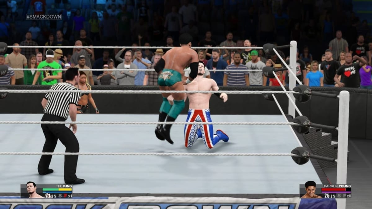 WWE 2K15 screenshot showing a wrestling match where one wrestler punches another in the groin