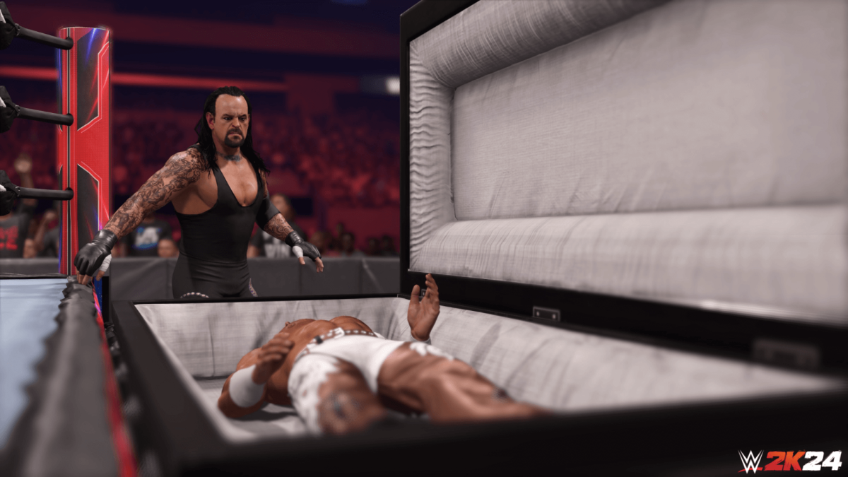 An in-engine screenshot of WWE 2k24, showcasing the Undertaker preparing to place his opponent inside a casket.