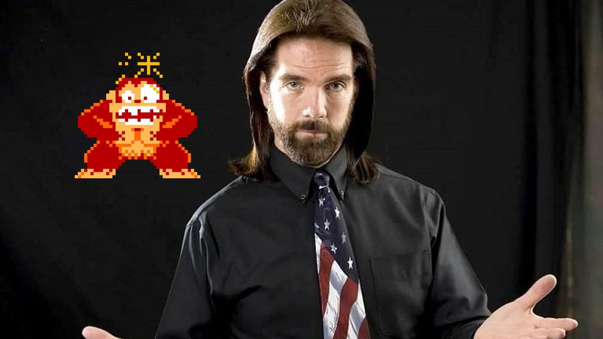 Billy Mitchell stands in front of an arcade sprite of Donkey Kong