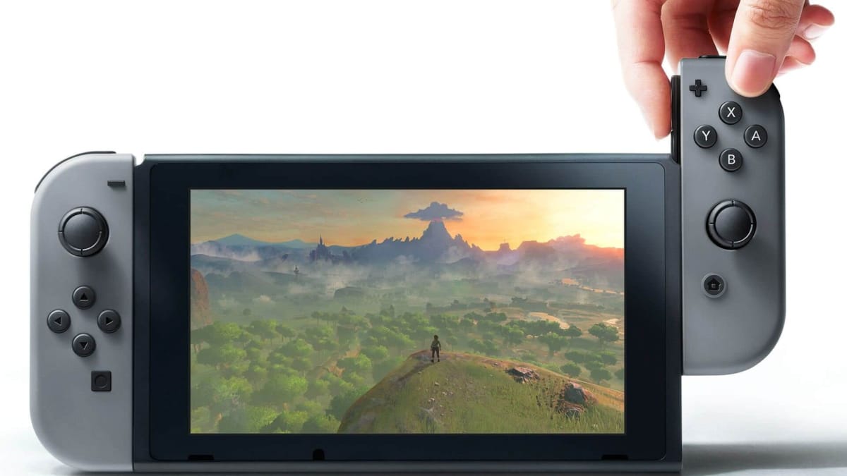 Someone removing or attaching a Joy-Con from or to the Nintendo Switch