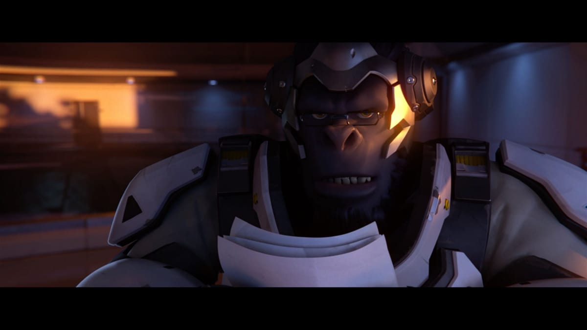 Overwatch cutscene showing a gorilla weraing glasses and a suit of futuristic armor as he stands staring at the camera. 