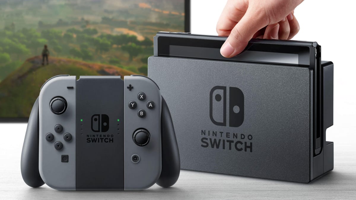 Someone docking the Nintendo Switch with the Joy-Con controllers next to it