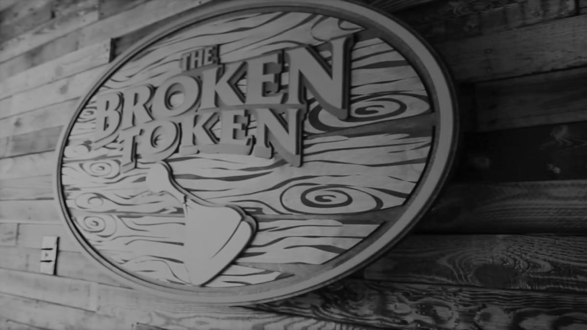 The logo of company The Broken Token in grayscale
