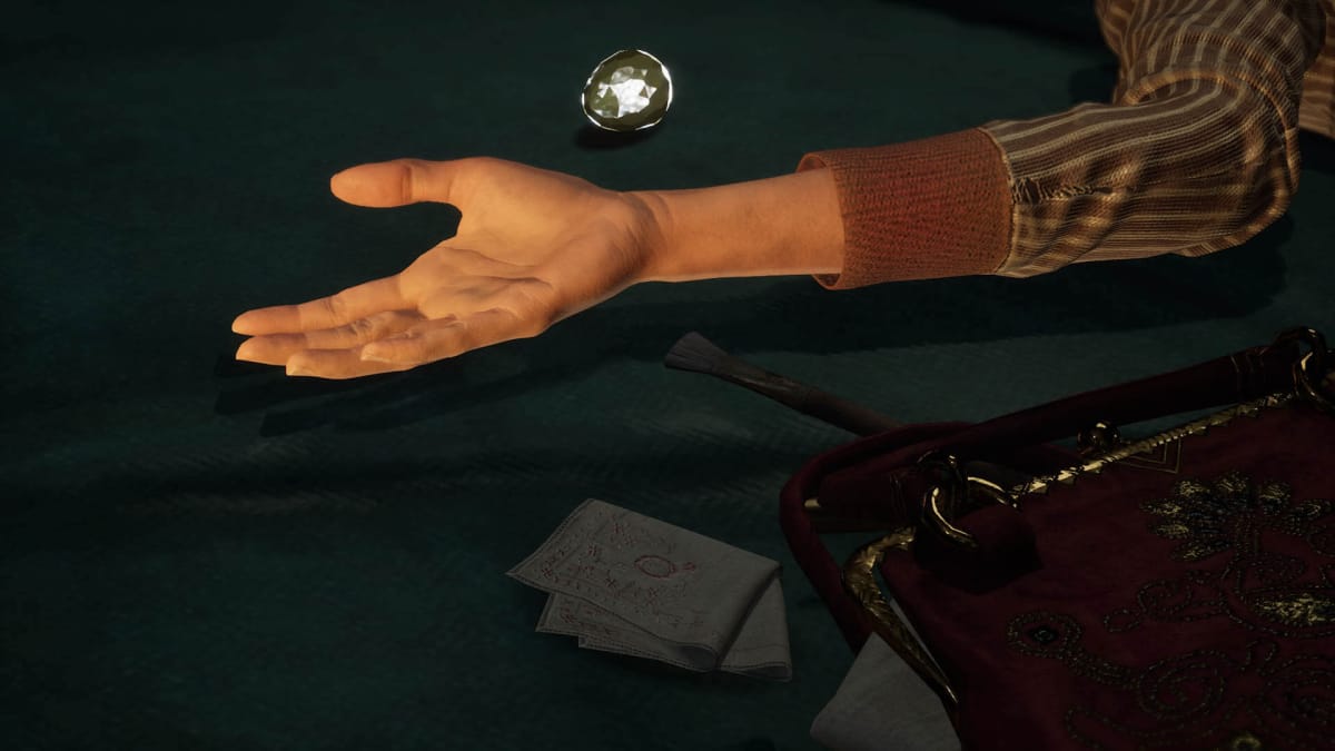 A woman's hand lying next to a diamond