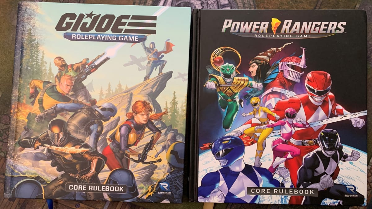 The GI Joe and Power Rangers Core Rulebook on a playmat