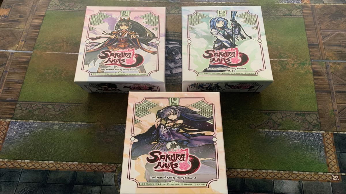 Three different Sakura Arms boxes on a gaming table