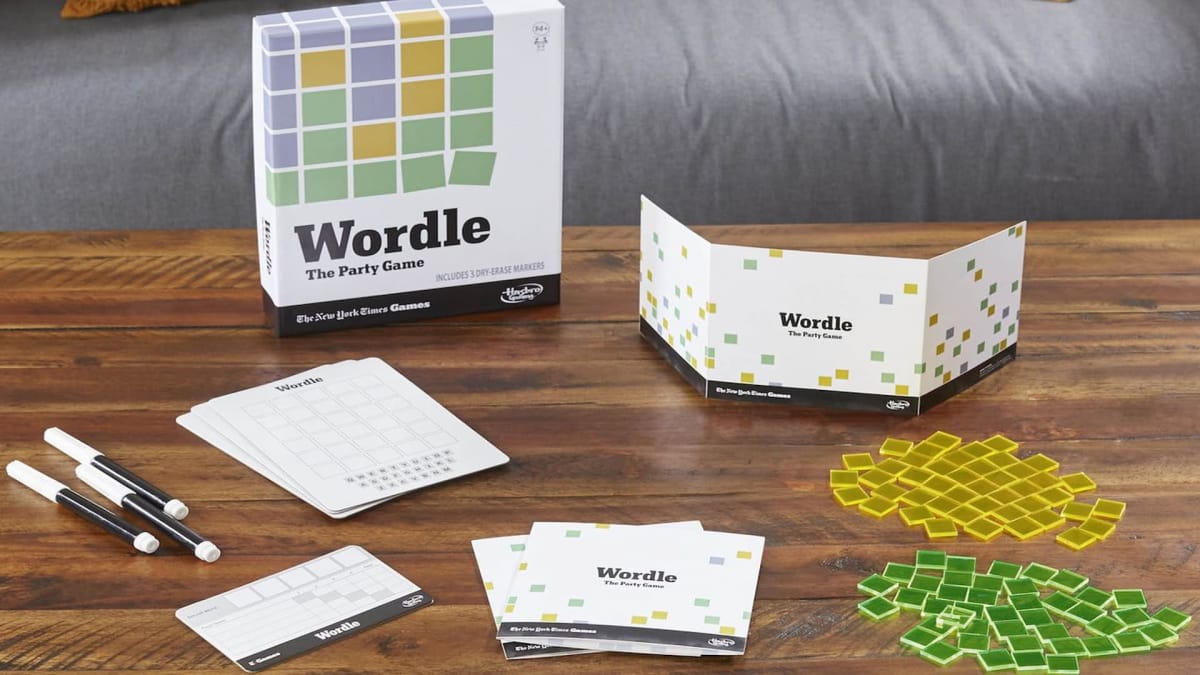 Photo of all of the Wordle party game pieces laying on a table. 