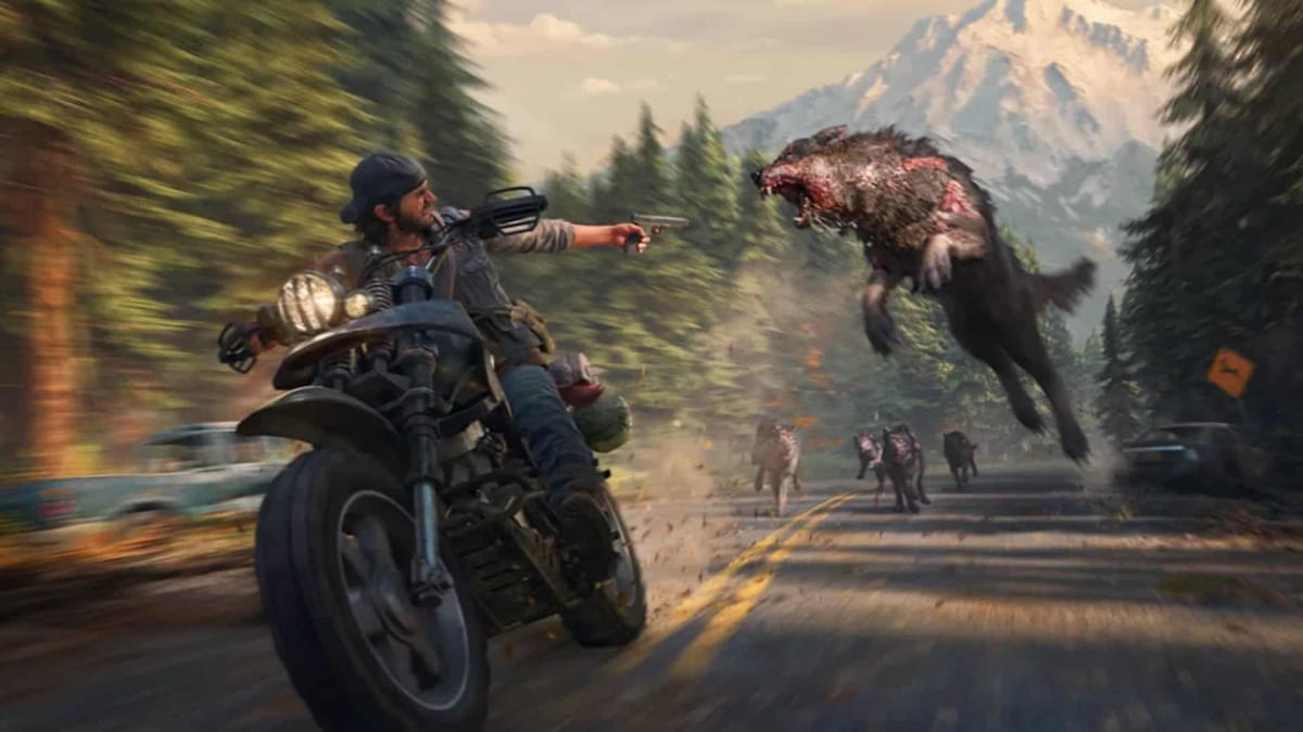 Days Gone in game screenshot of main character, Deacon St. John shooting his gun at rabid bloodthirsty wolves mid air as he rides his beloved motorcycle down the tree-lined highway