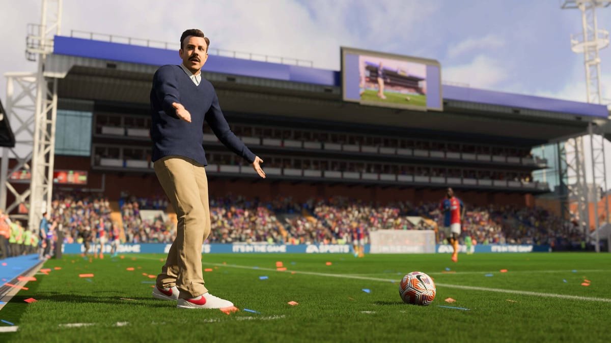 A man with a mustache (I'm sorry, FIFA fans, I don't know who he is) looks incredulous standing on the pitch in FIFA 23. Perhaps he's complaining about the FIFA 23 anticheat solution. 