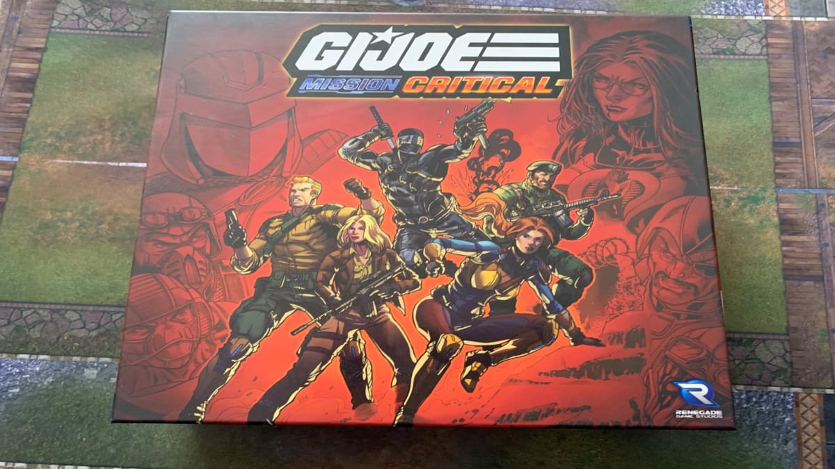 The game box of GI Joe: Mission Critical on a game mat.