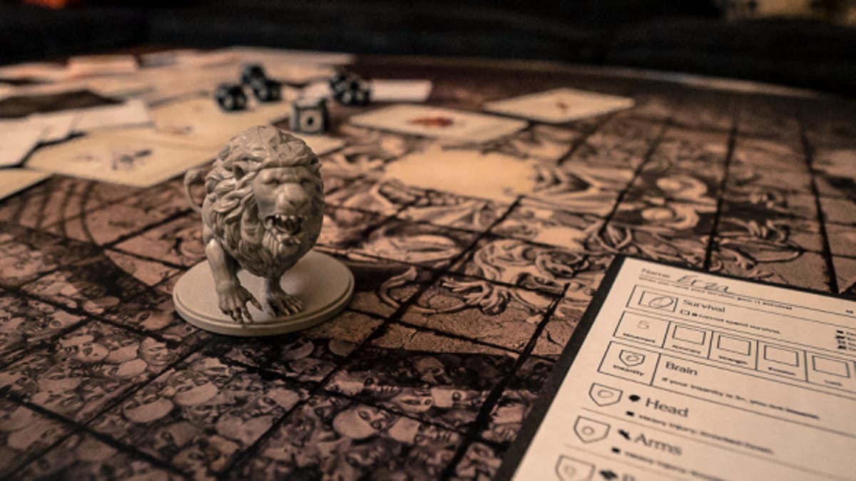 Kingdom Death Monster Board With Lion Figurine in the foreground and a character sheet in the bottom right. 