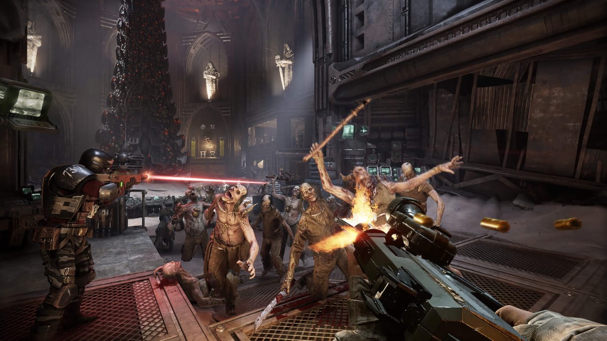 Two gunners shooting at a horde of enemies in Warhammer 40k: Darktide