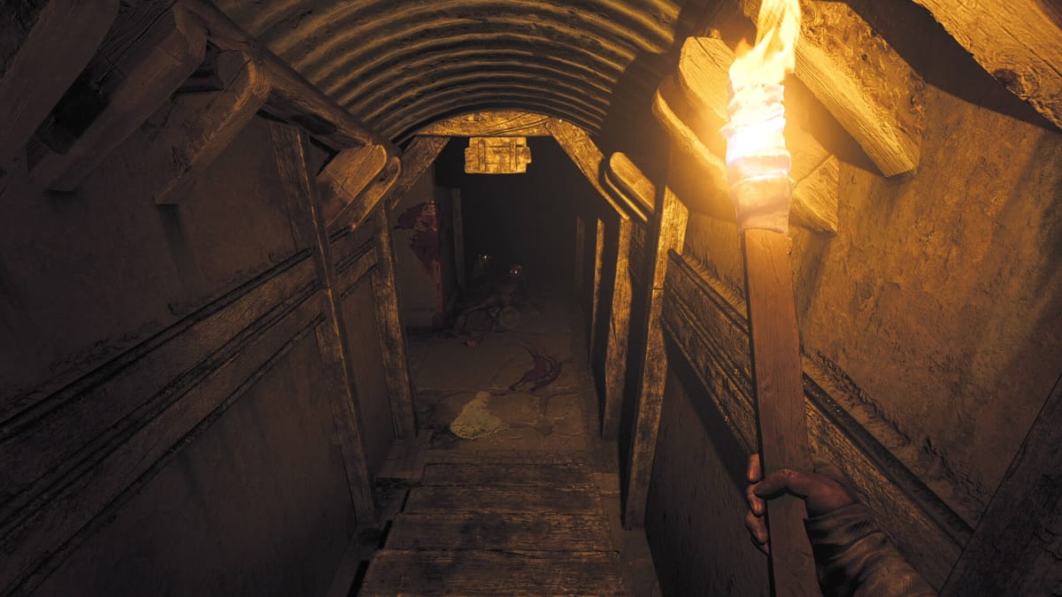 The player descending some stairs armed with a torch in Amnesia: The Bunker