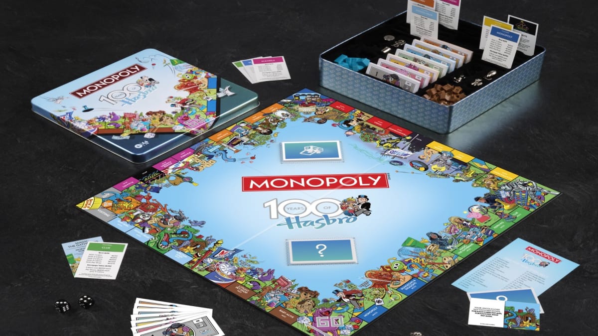 The board set up for Monopoly: Hasbro 100th Anniversary Edition showing cards, locations, and game pieces.