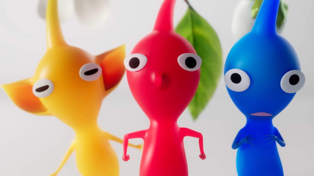 A Yellow Pikmin, a Red Pikmin, and a Blue Pikmin lining up and looking at the camera in the new Pikmin 4 trailer