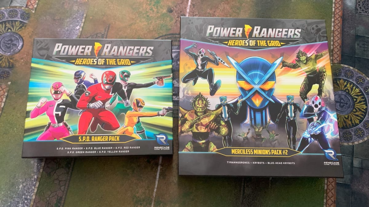Box art for the Power Rangers SPD Ranger Pack and Merciless Minions 2 on a gaming mat.