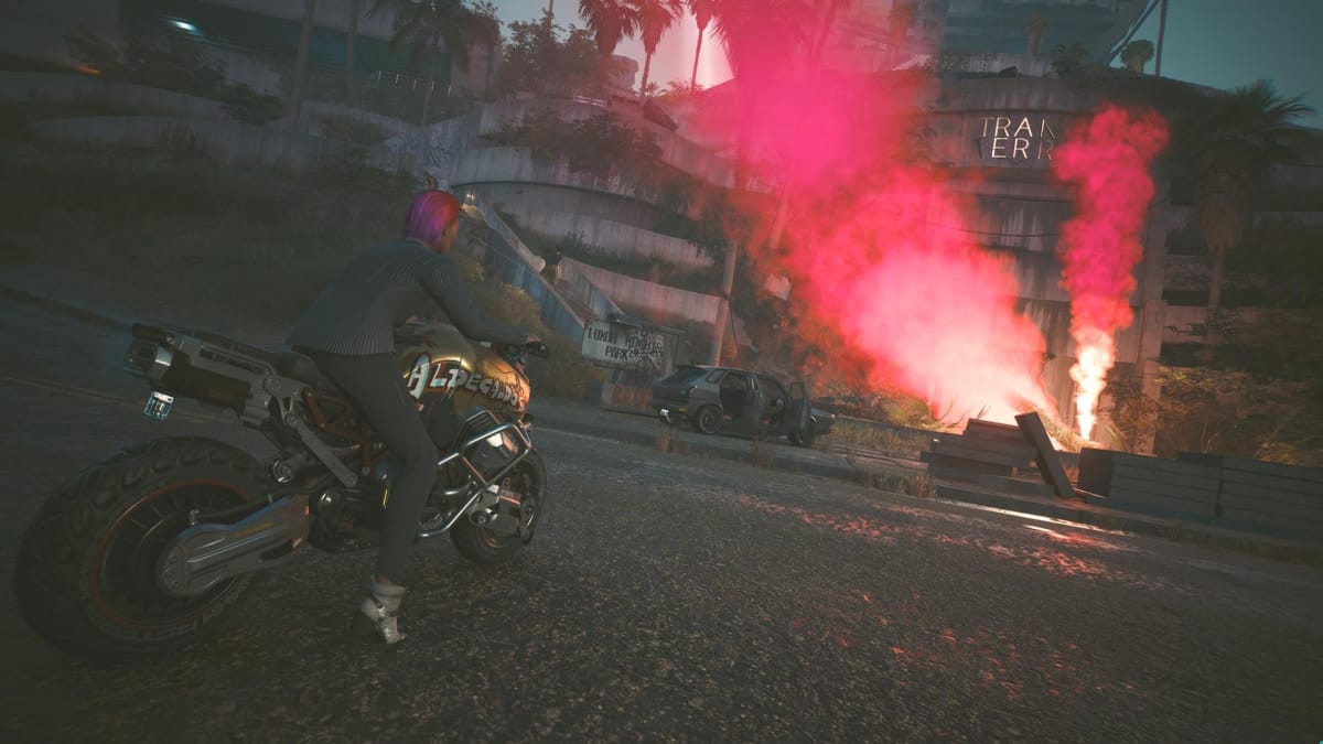 The player rides a motorcycle, while looking at red smoke that denotes the location of an airdrop.