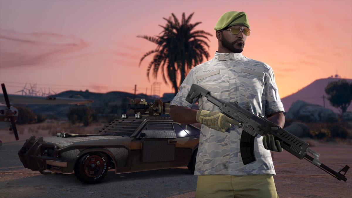 A man holding a rifle and standing in front of a heavy duty-looking military-style car in GTA Online, meant to represent Grand Theft Auto 6