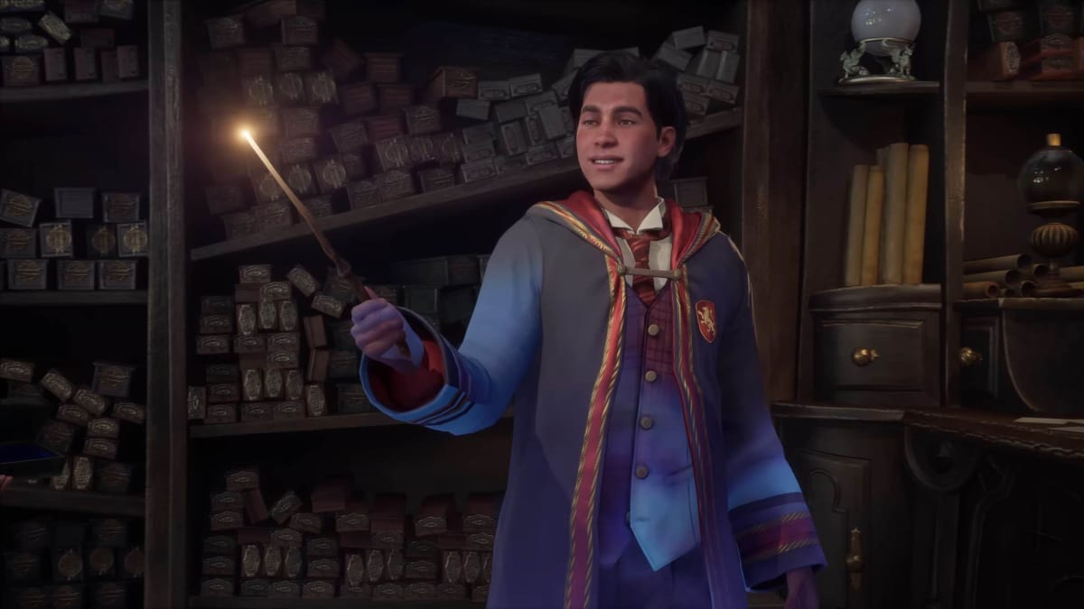 A student holding up their wand as it begins to glow in Hogwarts Legacy, which is number one in the UK boxed sales charts