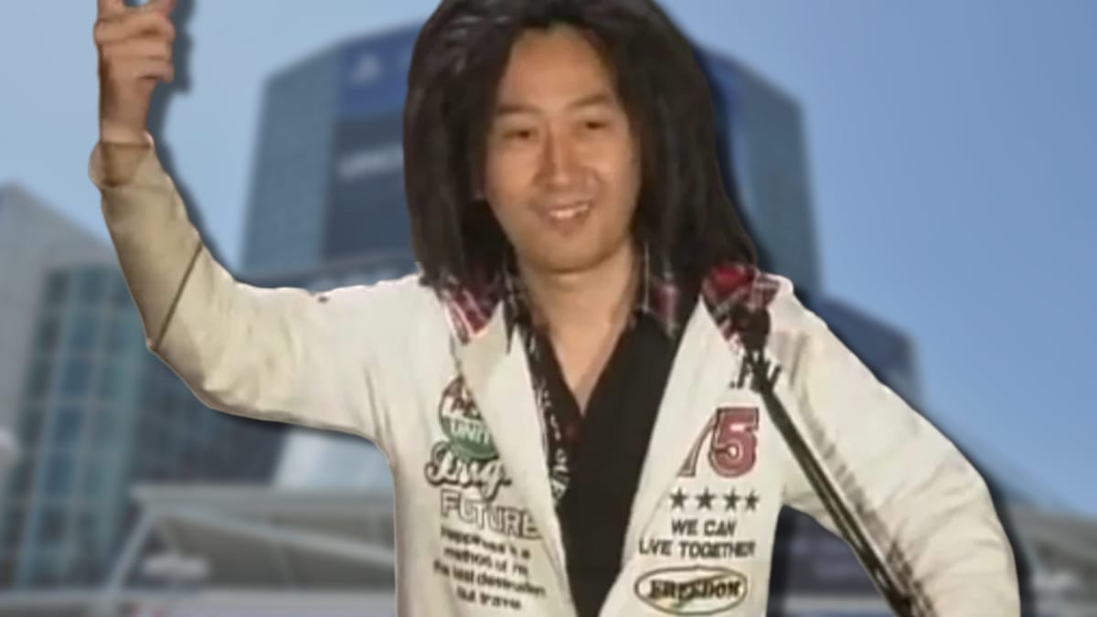 Tak Fujii can be seen with an image of E3's convention centre behind him