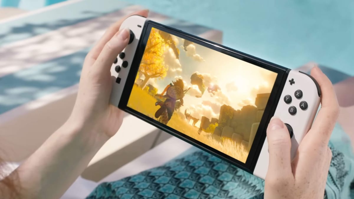 A woman holding a Nintendo Switch on which The Legend of Zelda: Breath of the Wild is being played