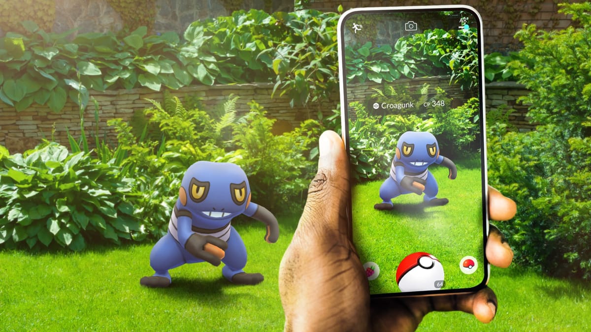 A player holding a phone up to a Croagunk in artwork for Pokemon Go