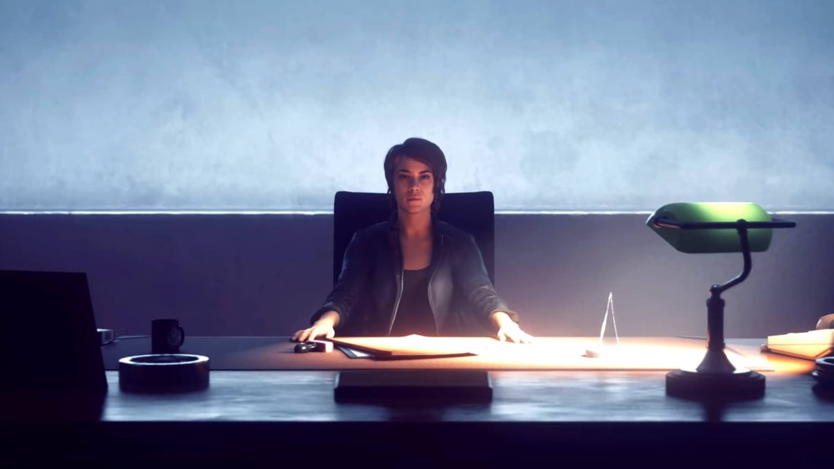 Jesse sitting behind a desk in the Remedy game Control