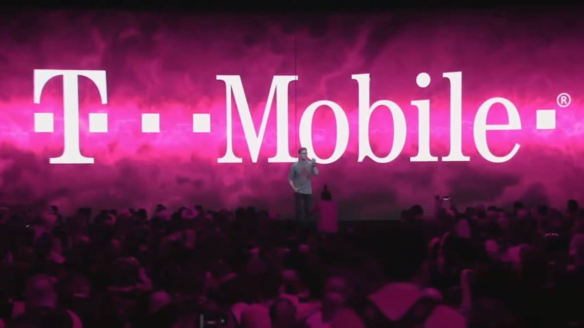Someone speaking in front of a T-Mobile logo