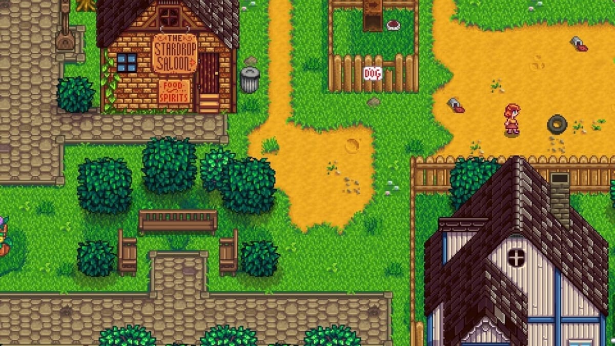 Stardew Valley Screenshot showing a brightly-colored pixel-art town with bright green grass and yellow firt paths everywhere. There are several houses in the image, as well as fences and natural features like trees and bushes. 
