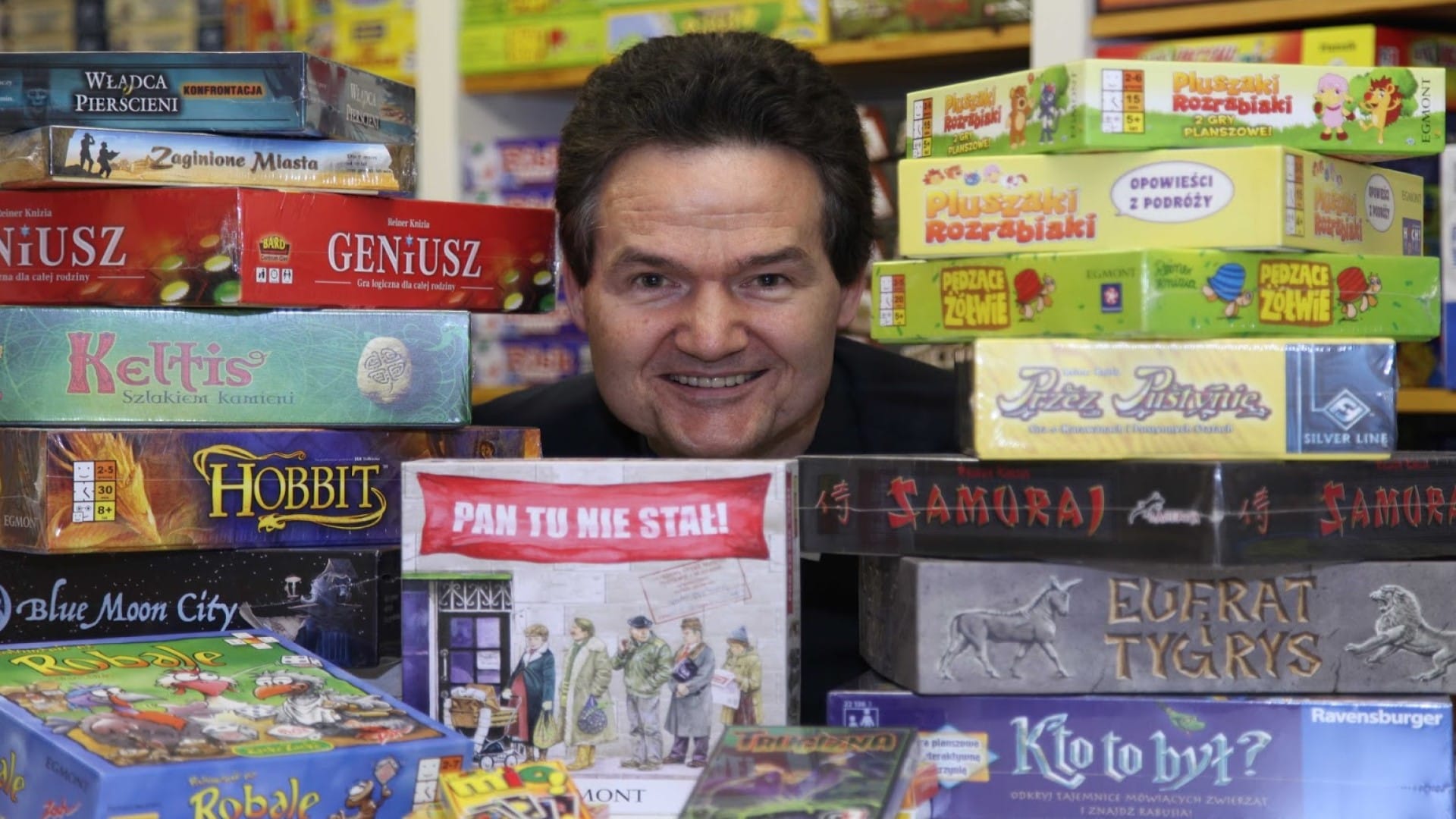 A snapshot of Reiner Knizia with the boxes of games he helped make