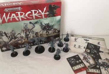 photo showing several miniatures sitting in front of a box for Age of Sigmar WarCry
