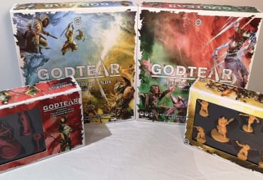 photo showing four boxes for the game Godtear sitting on a white table. 
