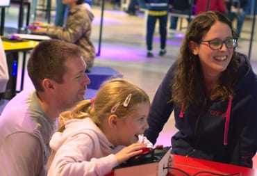 A family enjoys an exhibit at the National Videogame Museum
