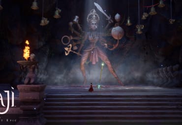 Raji standing in front of a statue of the god Vishnu