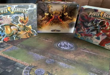 A photo of the Kickstarter box and the expansions propped up on a table