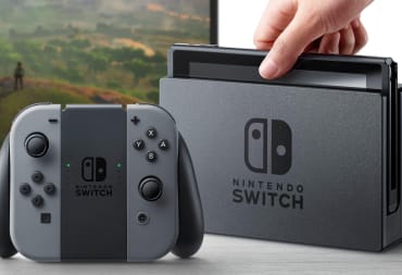 Someone docking the Nintendo Switch with the Joy-Con controllers next to it